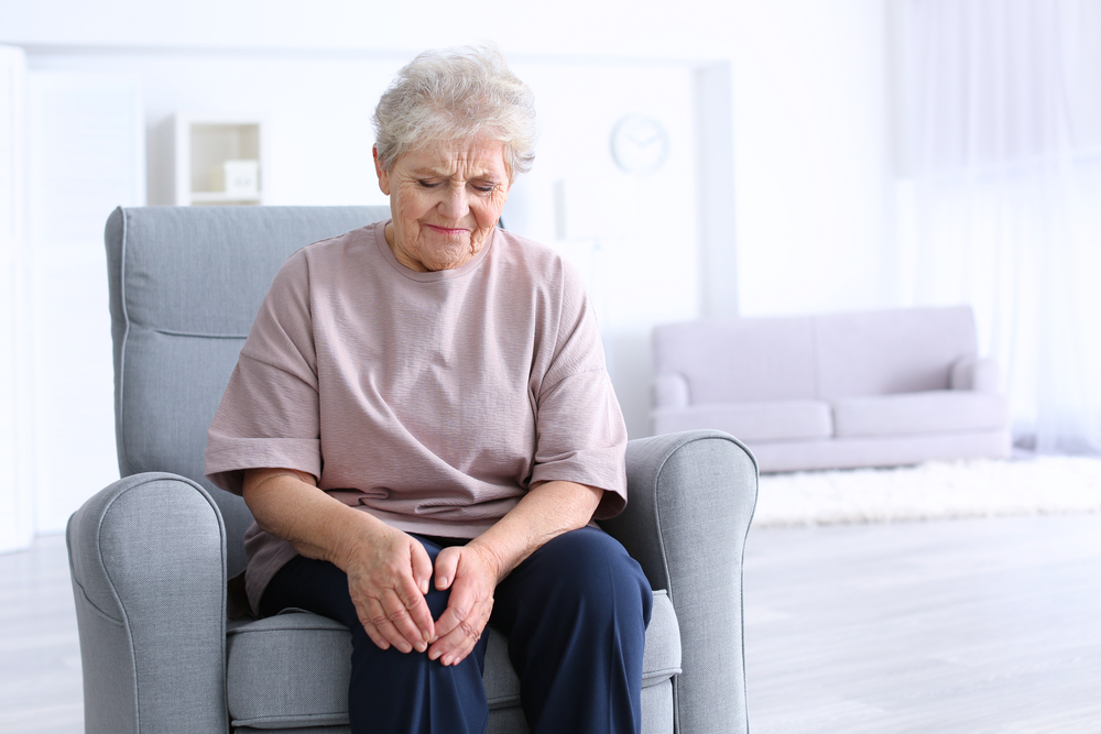 Elderly woman looks upset, possibly due to autoimmune disease worries