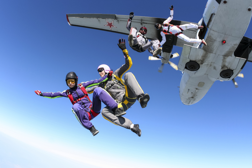 skydivers leap from plane, embodying acute stress thrill