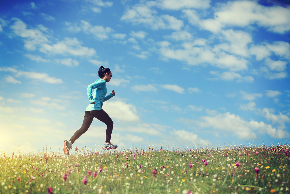 Women running in a field symbolizing active lifestyle's role in autoimmune health