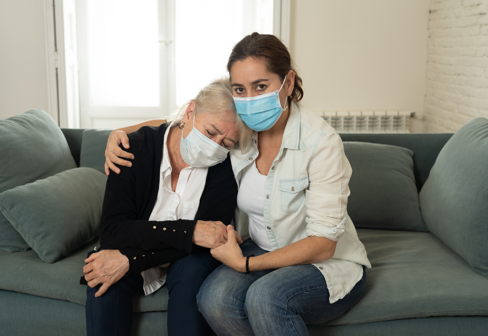 Daughter consoles senior mother, pondering if autoimmune conditions are inheritable.