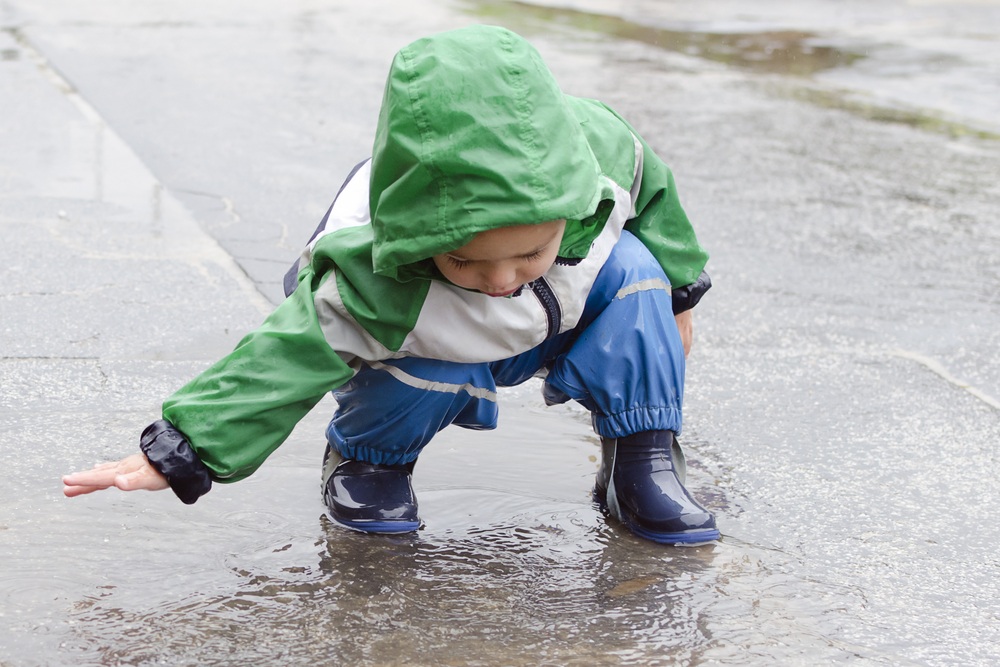 Child in rain pondering the rise of autoimmune diseases